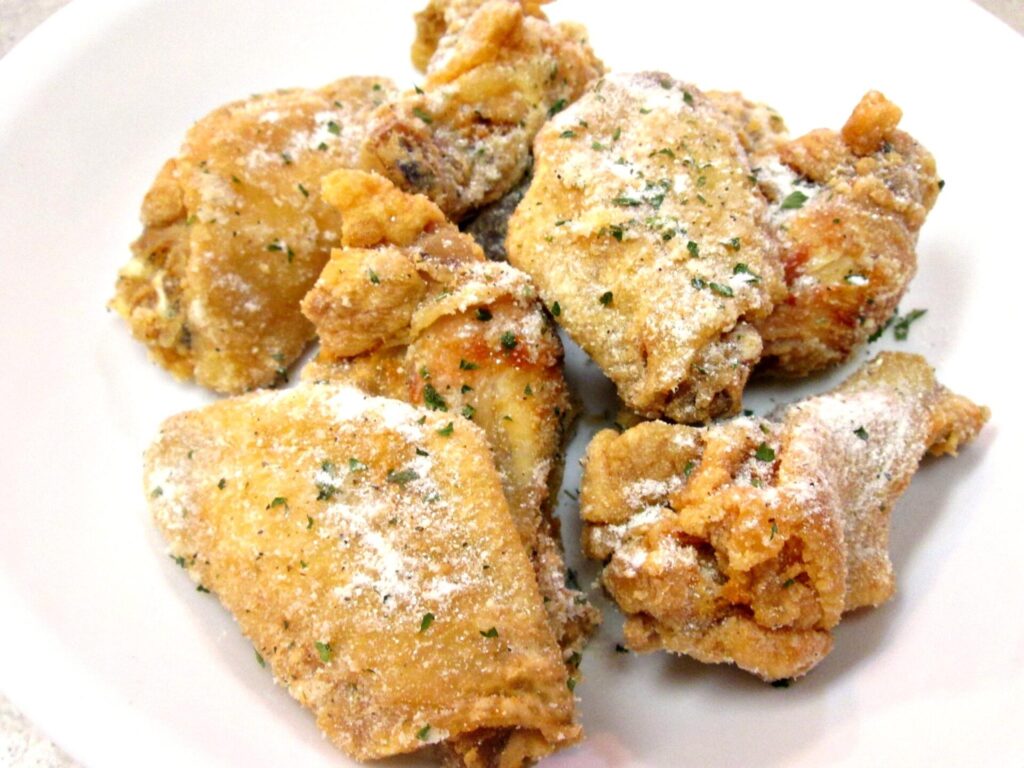 Ranch-flavored chicken wings arranged on a serving plate with dipping sauce.