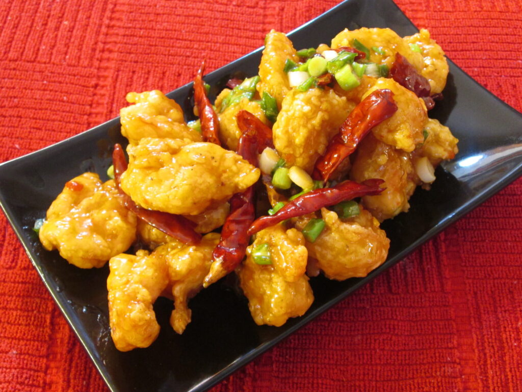 Deep fried shrimp tossed in a creamy sweet and spicy sauce with small red chili's and chopped scallions.