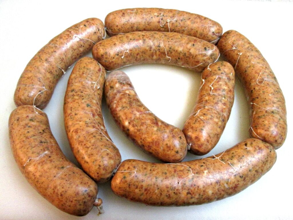 Nine freshly stuffed Italian sausage links, perfectly tied and ready for cooking or storage.