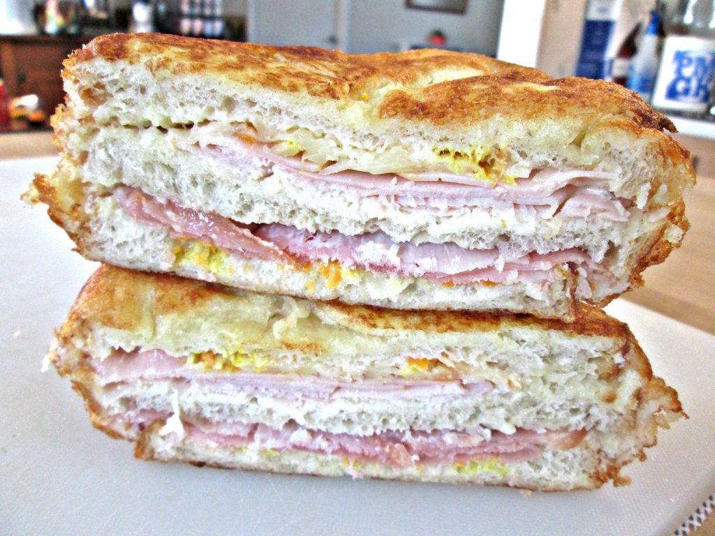 Inside view of a homemade Monte Cristo sandwich with melted cheese and ham.