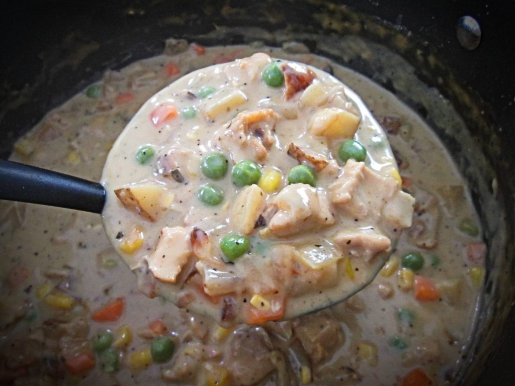 Cooking process of Chicken Corn Chowder in a pot.