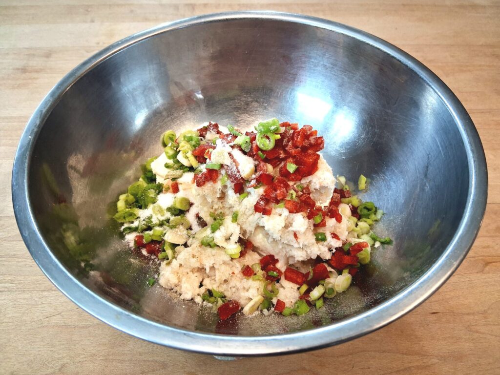 Cream cheese and crab filling mixture in a bowl for homemade Crab Rangoon.