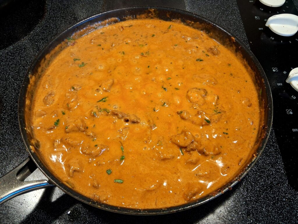 Deep, golden curry gravy simmering with tender chicken and coconut milk.